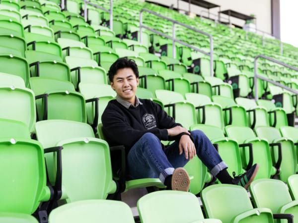 Tony Ho ’21 smiles for a photo at the Austin FC Stadium.