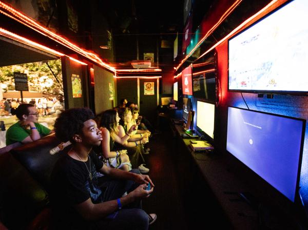 Students play video games at a back-to-school event.