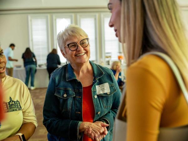 Glenda Ballard speaks with other faculty and staff.