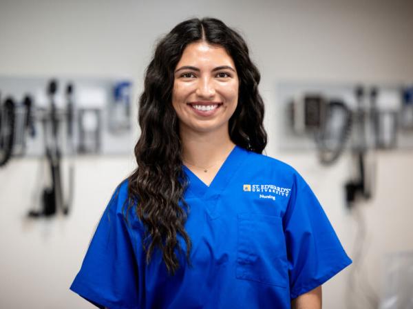 student nurse in blue scrubs