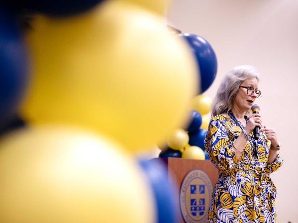 Lisa Kirkpatricks speaks into a microphone.