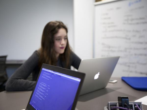 Computer Science student works on her computer during class