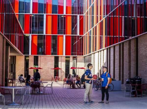 Students gather and socialize in the colorful atrium of the Residential Village on the St. Edward's campus.