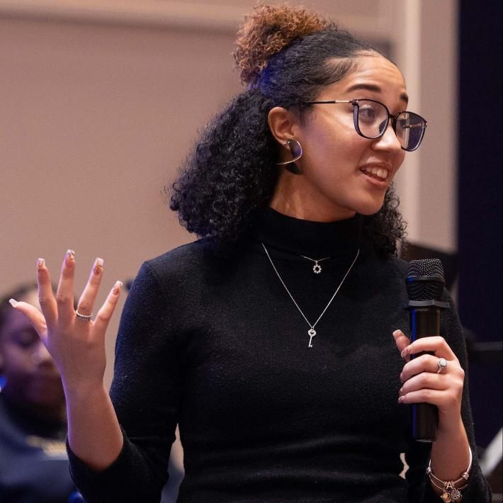 Alexis Reed publicly speaking at the Power to the People event