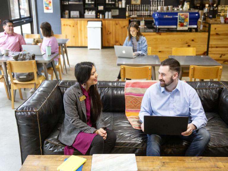 Student and a professor talking in a coffee shop