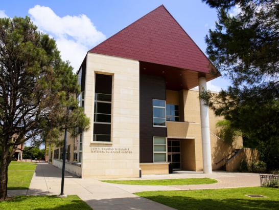 The exterior of John Brooks Williams Natural Sciences Center - North, framed by trees.