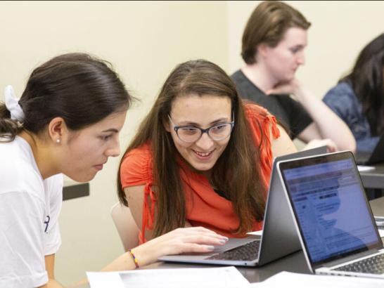 Students working together on the computer in their classroom.