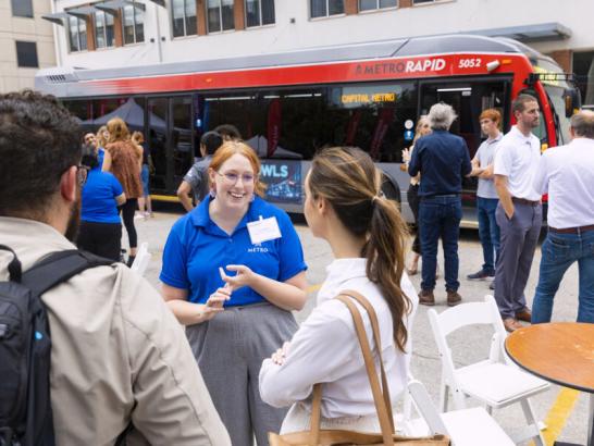 Students engaging with CapMetro, Austin's public transit system, employees about their buses.