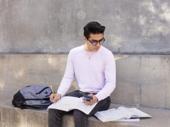 Student using a calculator while working on math homework.