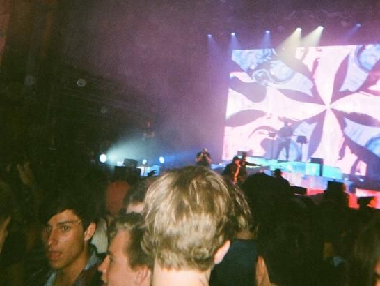 A large crowd and a stage with purple lights