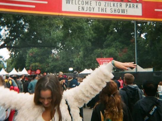 A woman dancing underneath the ACL entrance gates