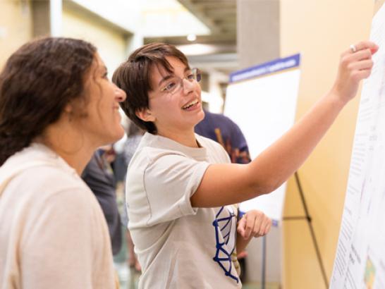 i4 student showcases their reseach at the annual on-campus symposium.