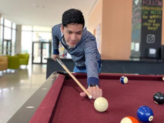 A student playing pool