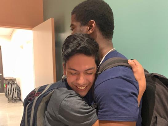 Two students hugging