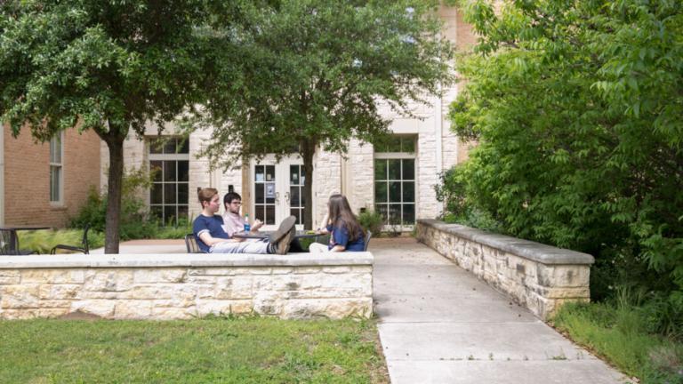 Students sitting outside Jacques Dujarié Hall