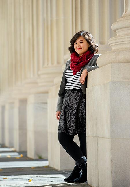 Amy Ontai stands between a row of pillars at Yale University