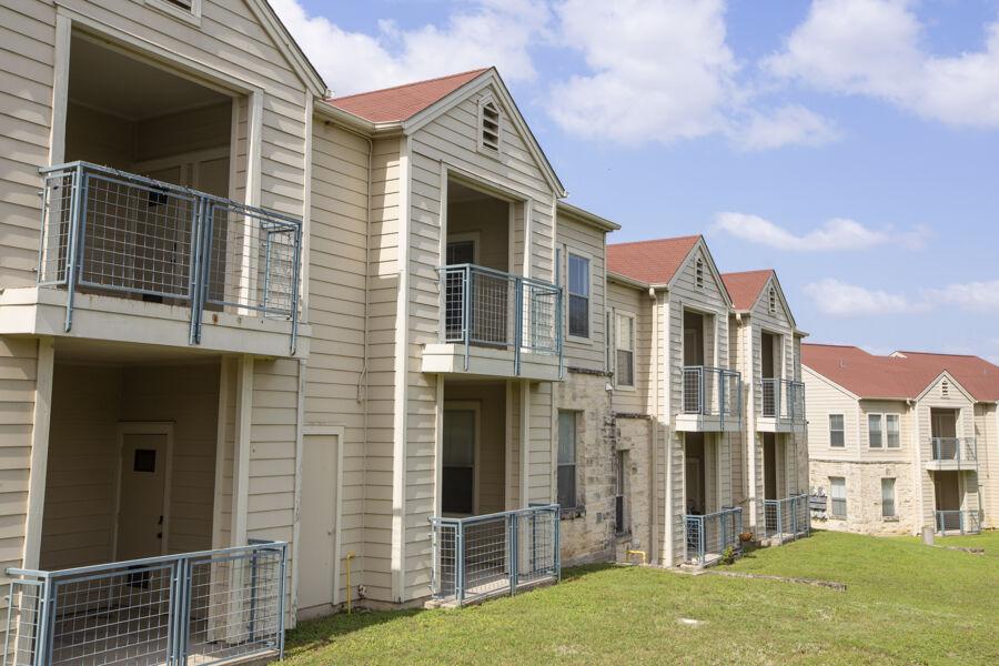 A line of apartment buildings with red rooves