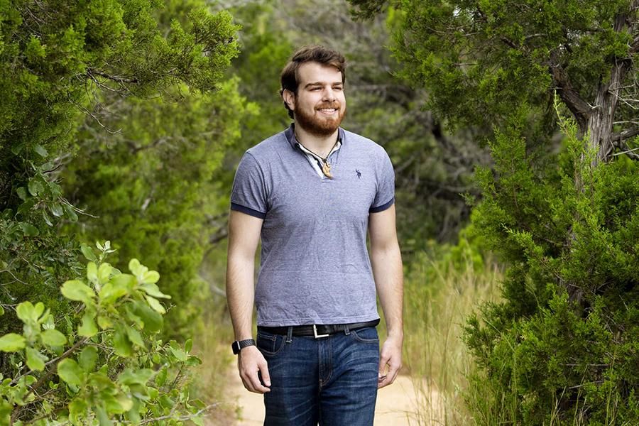 Andres Targa walks on a path at Wild Basin.