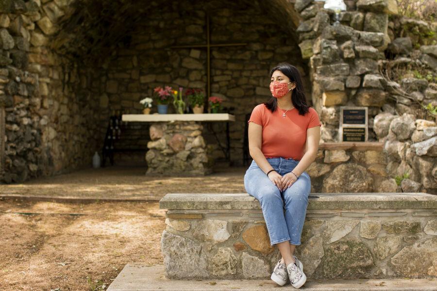 student sitting outside grotto