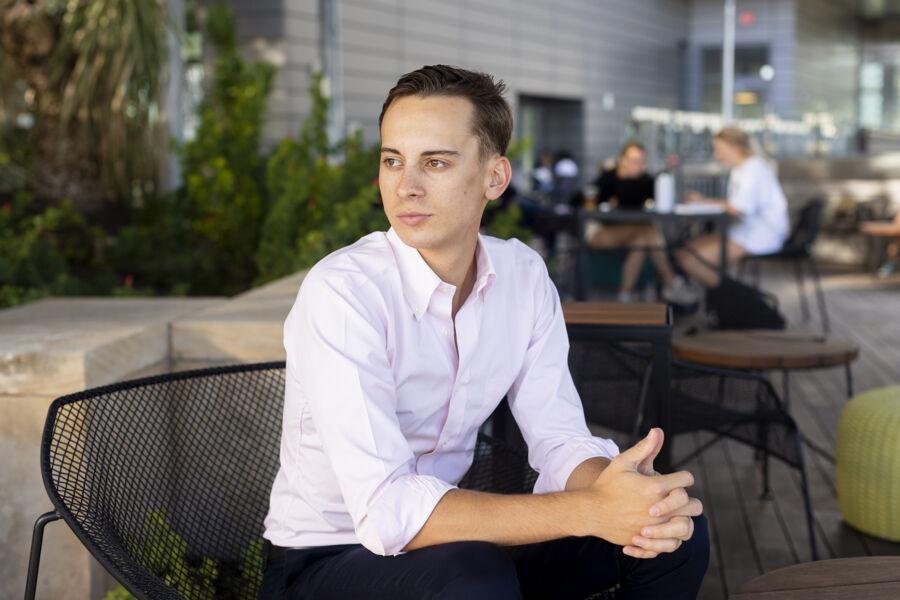 Christoph Hoermann sits in a chair on the rooftop patio of the Austin Public Library.