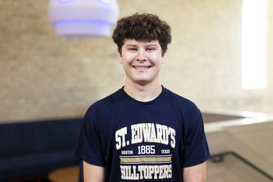 Liam Quinn stands in Holy Cross Hall.