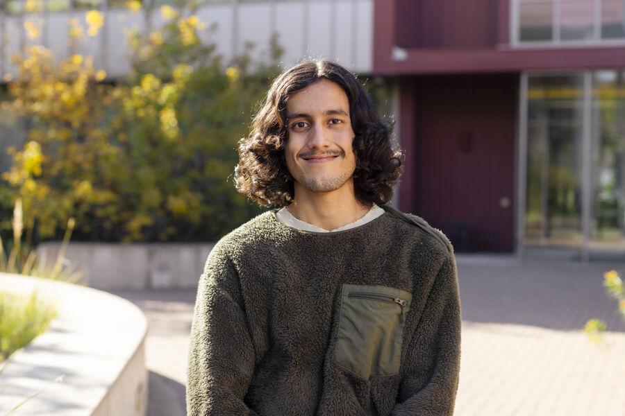 Lalo Carrillo stands in the John Brooks Williams Natural Sciences Center courtyard.