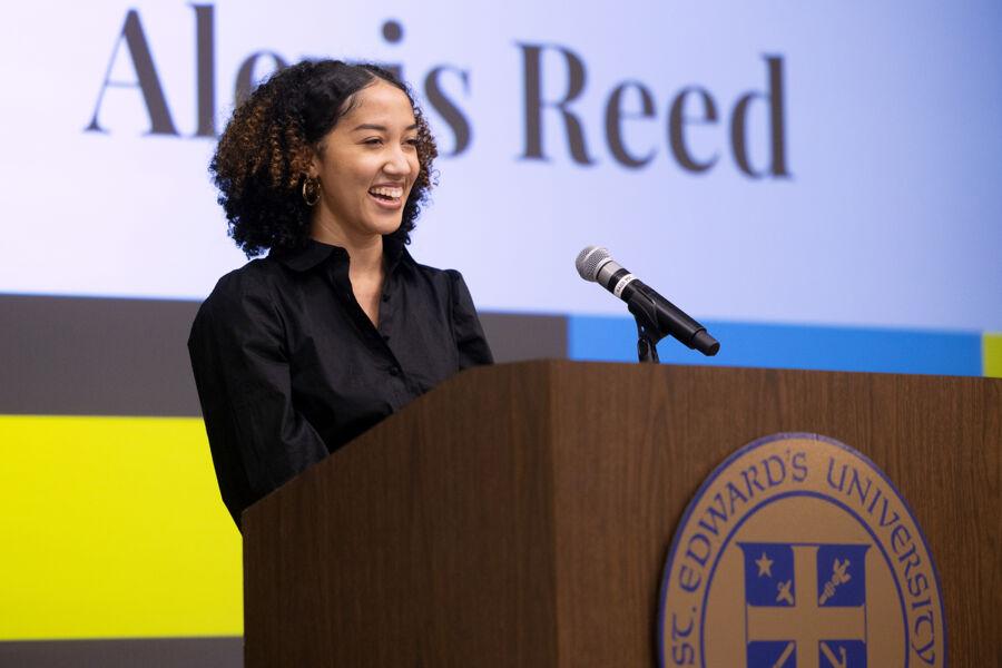 Alexis Reed speaking at the podium at Black Student Graduation.