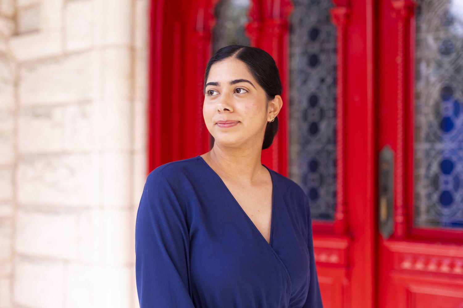 Simran Chadha in front of red doors