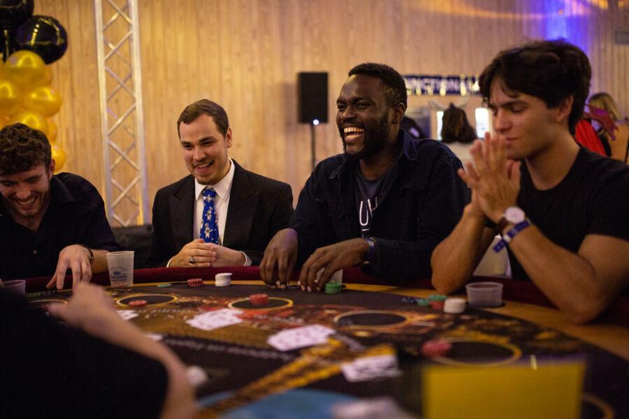 Students play a casino game at casino night.