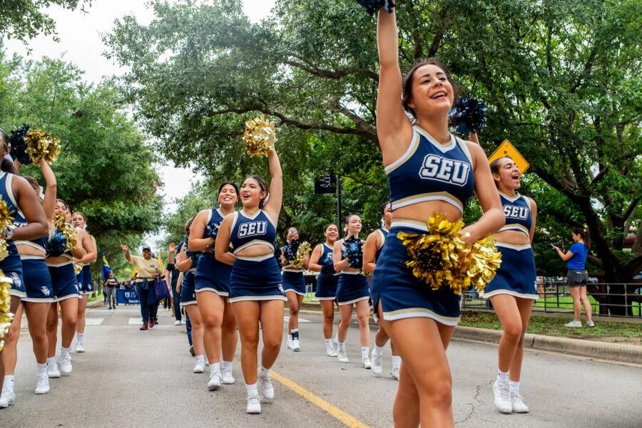 Cheerleaders march in the homecoming parade.