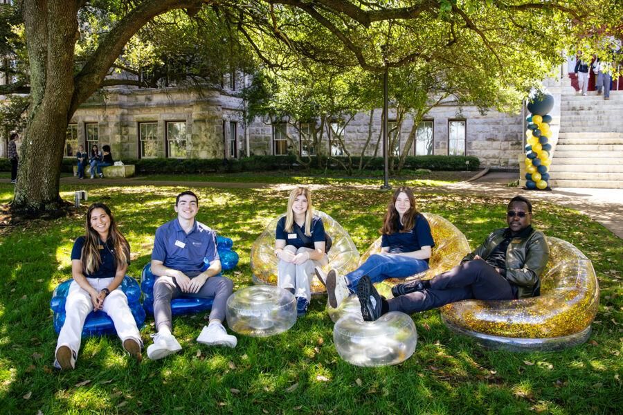 Students sit on inflatable chairs outside of Main Building.