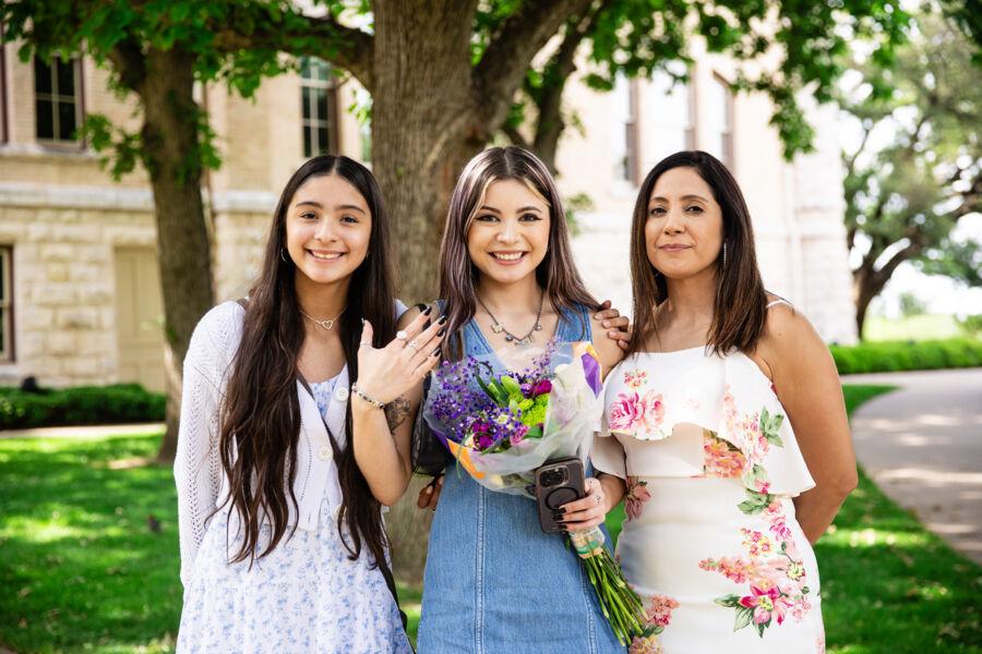 a student showing off their ring with their family after ring ceremony.