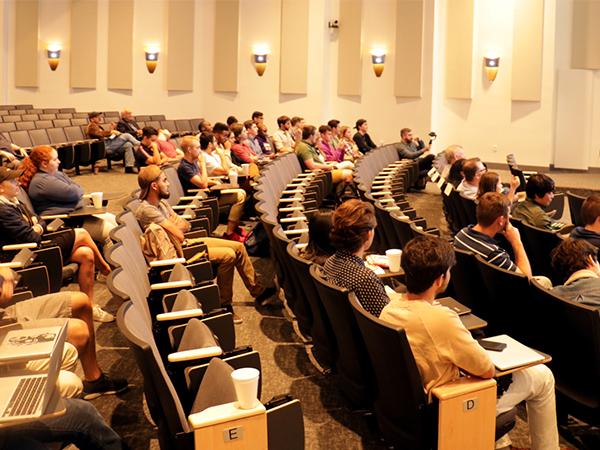 student sitting in a presentation room 