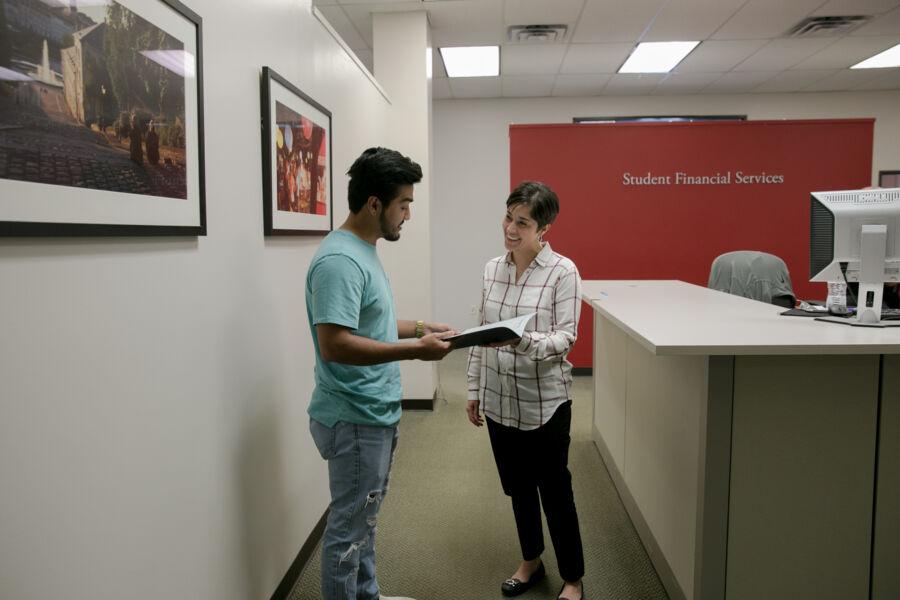 A student receives financial advice from a staff member at St. Edward's University Student Financial Services.