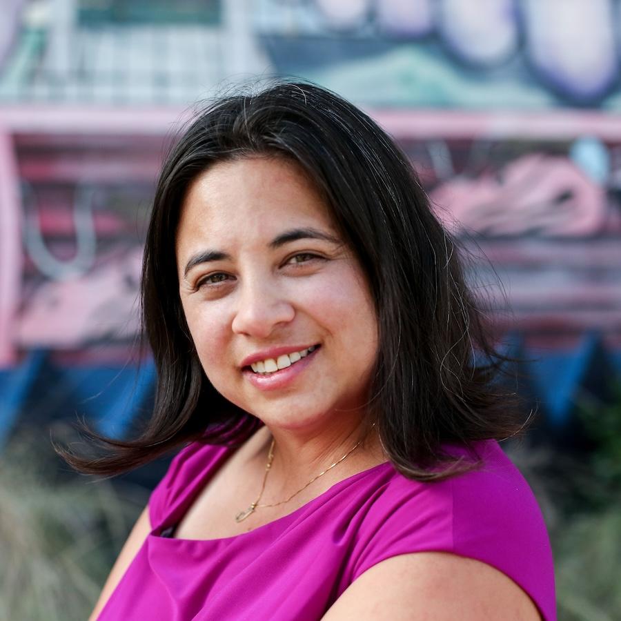 Jennifer Rangubphai wears a fuschia blouse.