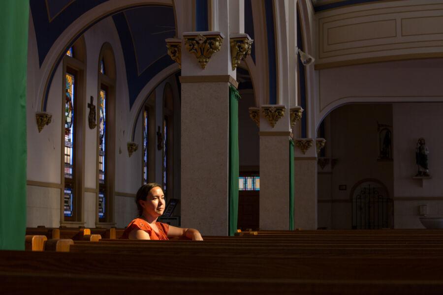 Victoria Rodriguez sits in the pews of her church.