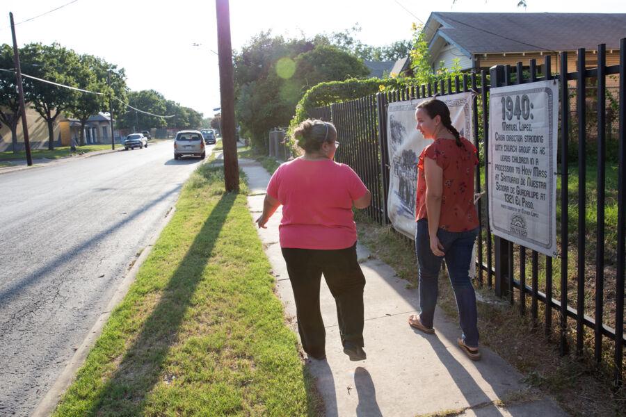 Victoria Rodriguez and her mother walk on a sidewalk in their neighborhood.