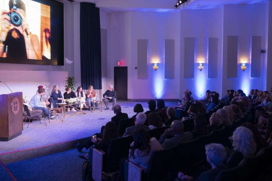 Photocommunications alumni share advice on a panel to a listening audience in Jones Auditorium.