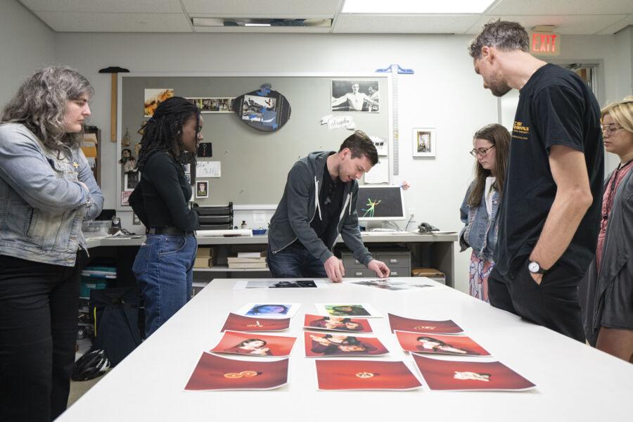 Students listen as a photocommunications alum gives a portfolio review.