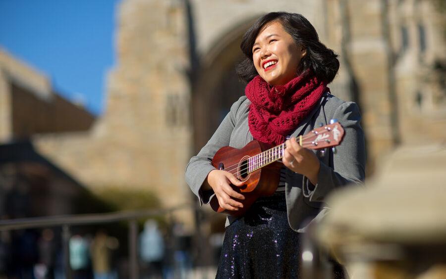 Amy Ontai plays the ukulele outside.