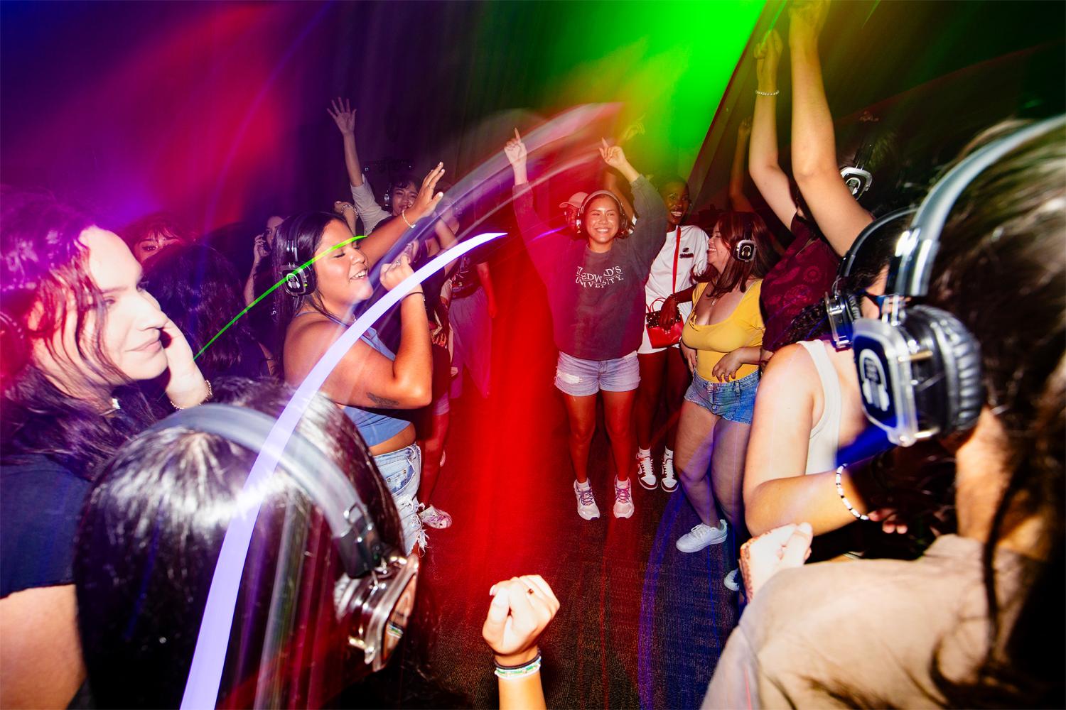 students dancing in a silent disco at anchors event