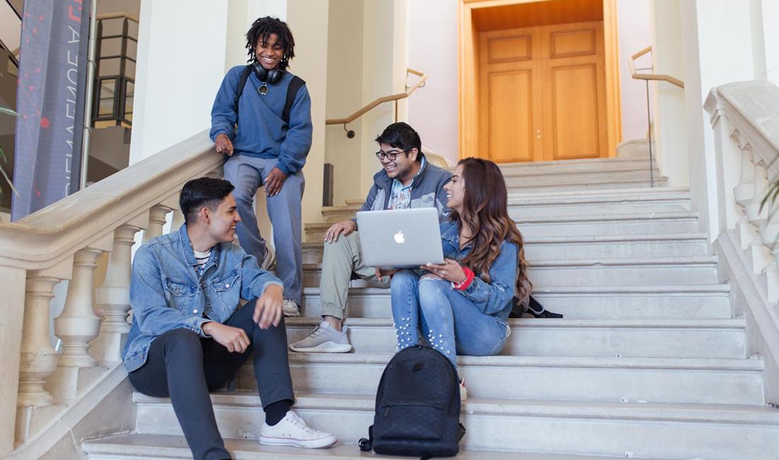 Reyes and his classmates Lynnwood, Daniel and Dariela sitting on steps