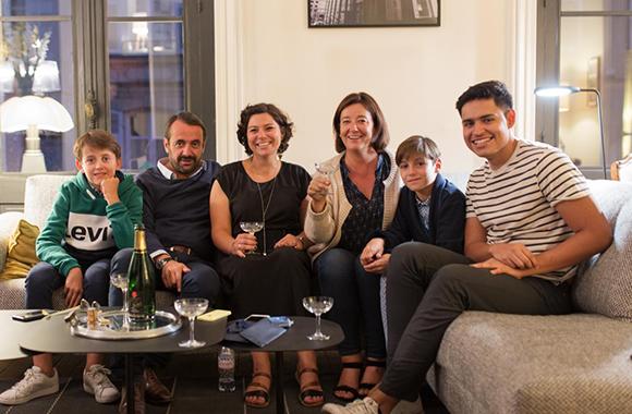 reyes poses for a picture with his host family in the living room