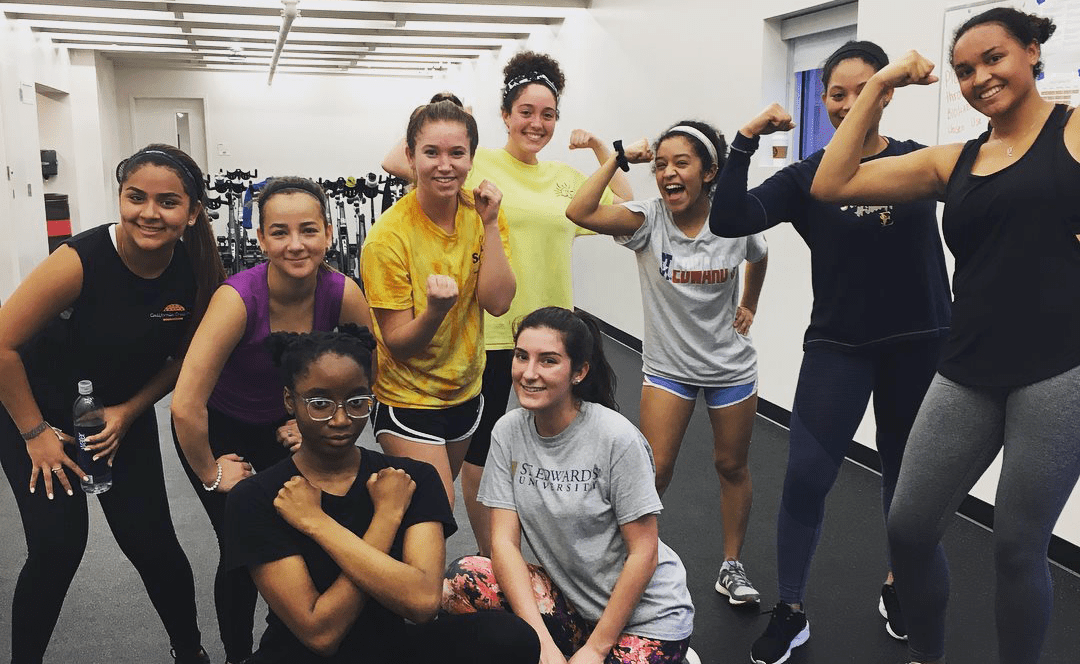 Students in fitness class pose for group photo 