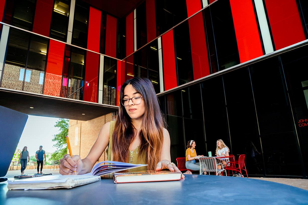 student sitting in patio