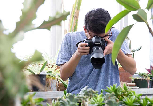 joshua rios taking a picture of the plants