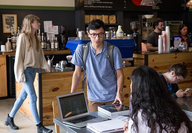  Rios stops by Meadows Coffeehouse on campus for a chat with friends.