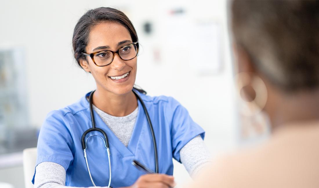 Nursing student speaking with a colleague