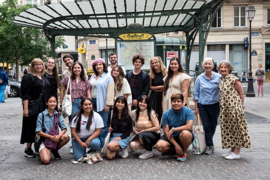 St. Edward's students and professors pose for a photo on a Paris street corner during their study abroad experience..