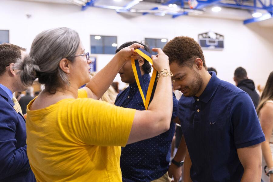 A student receiving a medallion at the medallion ceremony